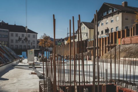 Reinforced concrete foundation with steel rebar for new construction site, urban residential area, building development, construction progress, foundation work.